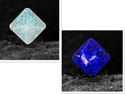 Galactic edition pocket gyro desk toy on a surface, showing its quadrilateral resin construction and celestial colour design.
