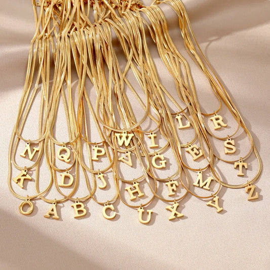 Elegant gold A-Z letter pendant necklace on a snake chain