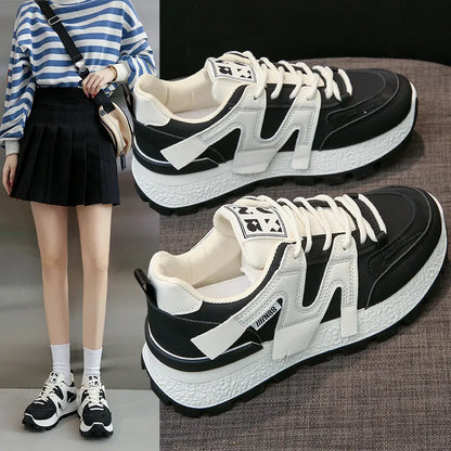 Low-top casual sneakers in black and white with rubber soles and lace-up front closure