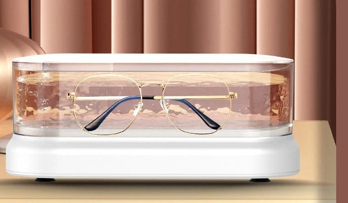 Compact ultrasonic cleaning machine for watches and small items, white colour, on a table