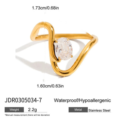 Geometric titanium steel ring with zircon stones in a silver tone on a grey background.