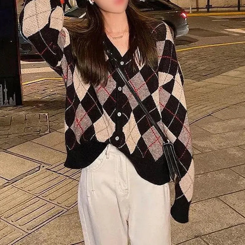 Long sleeve knitted cardigan in a light khaki colour, shown open over a white top, demonstrating its relaxed fit and medium weight.