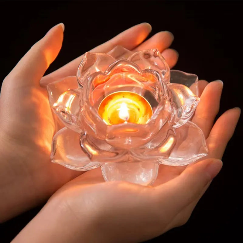 Glass lotus-shaped aromatherapy candle cup on a table.