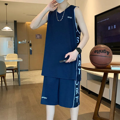 Man wearing a grey sleeveless basketball vest and matching shorts for sports.