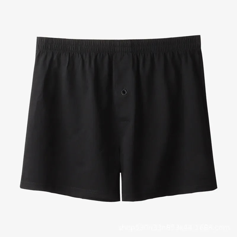 Men's light grey cotton boxer shorts with a loose fit and high waist on a plain background.