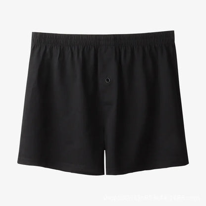 Men's light grey cotton boxer shorts with a loose fit and high waist on a plain background.
