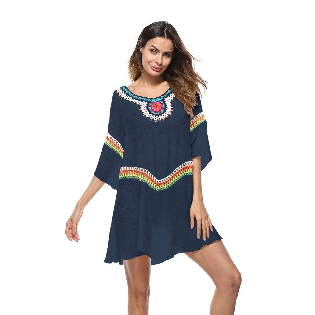 Crocheted white beach cover-up with open-knit design, worn over swimsuit, demonstrating UPF 50+ sun protection.