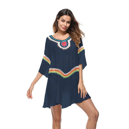 Crocheted white beach cover-up with open-knit design, worn over swimsuit, demonstrating UPF 50+ sun protection.