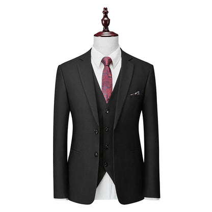 Man wearing a navy blue plaid slim-fit three-piece suit with jacket, waistcoat, and trousers