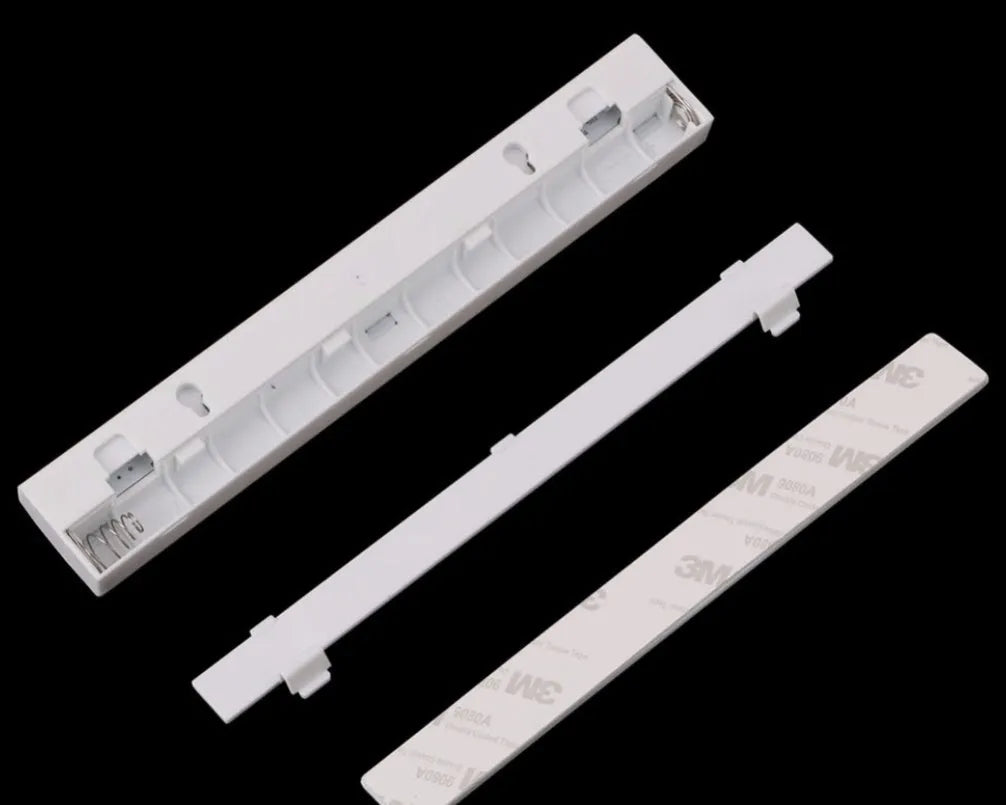 A matte aluminium LED closet light with a magnetic back, shown mounted inside a wooden wardrobe.
