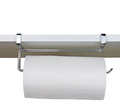 Silver stainless steel paper towel rack hanging on a cabinet door