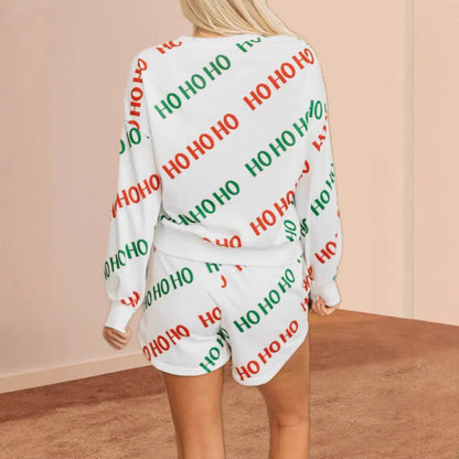 White women's two-piece suit with printed letters design, long sleeves, and matching trousers