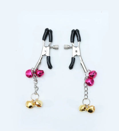 Red and purple nipple clamps with small bells and feather decorations for adult sensory play.