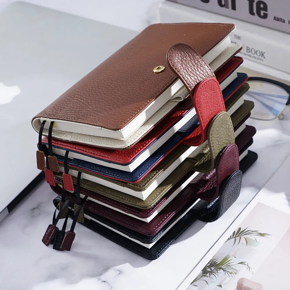 Close-up of a hand-embossed lychee pattern on an off-white A6 cowhide leather notebook with loose-leaf binding.