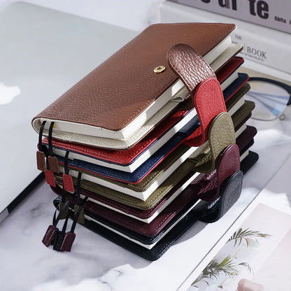 Close-up of a hand-embossed lychee pattern on an off-white A6 cowhide leather notebook with loose-leaf binding.