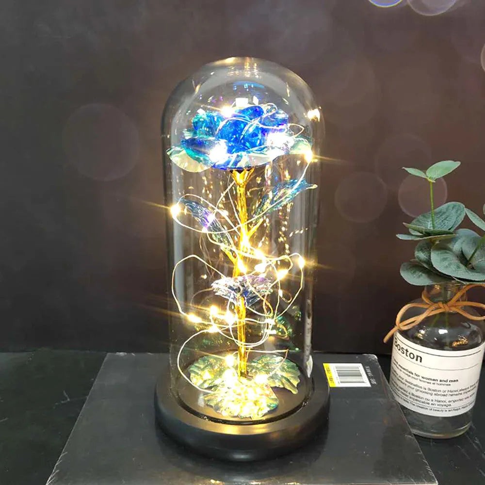 LED simulation rose ornament with glass lampshade on a solid wood base, showing a choice of rose colours.