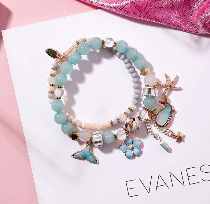 Whale tail bracelet with retro flower and starfish accents, a charming nautical accessory for UK fashionistas