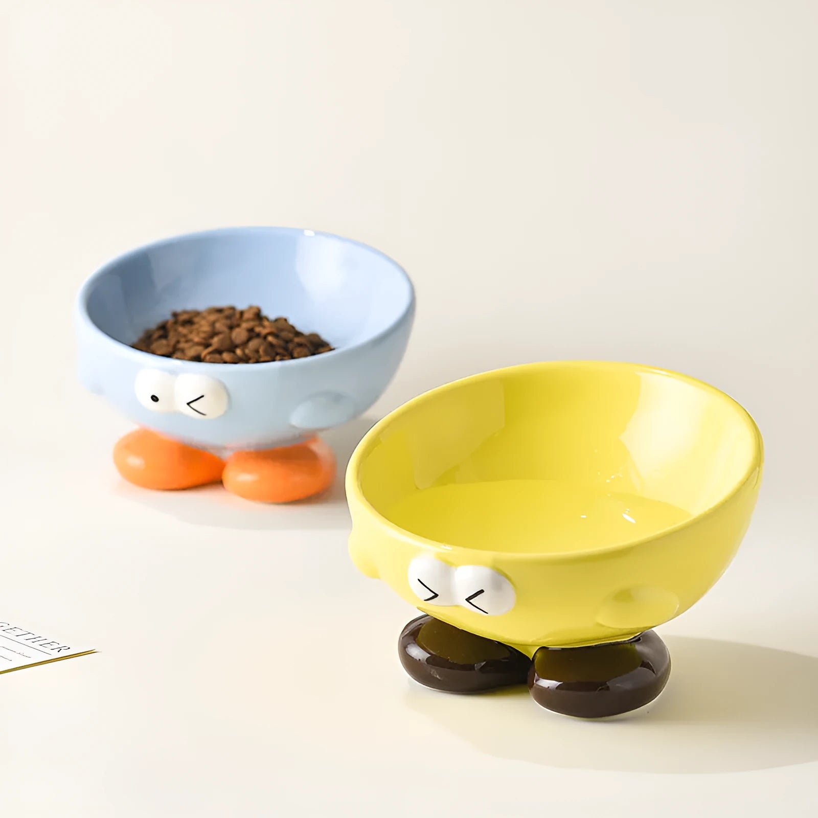 Ceramic slanted pet bowl with decorative expression pattern in blue colour
