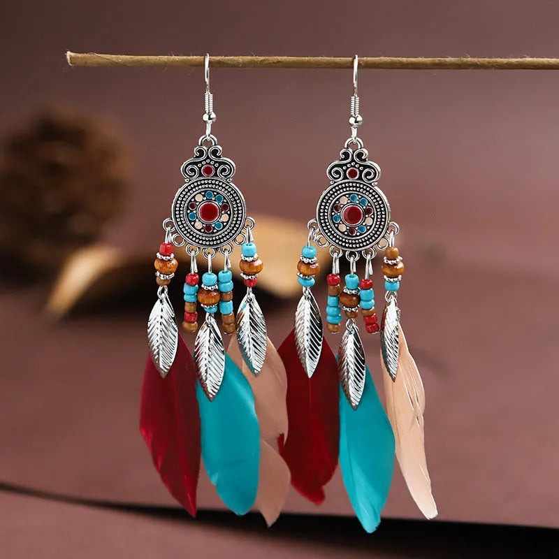 Round drop feather earrings in a bohemian leaf shape with patterned detail, shown in a light pink electroplated colour.