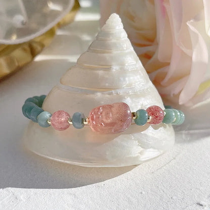 Simple blue jade bracelet with gourd charm, peace buckle, and adjustable cord on woman's wrist