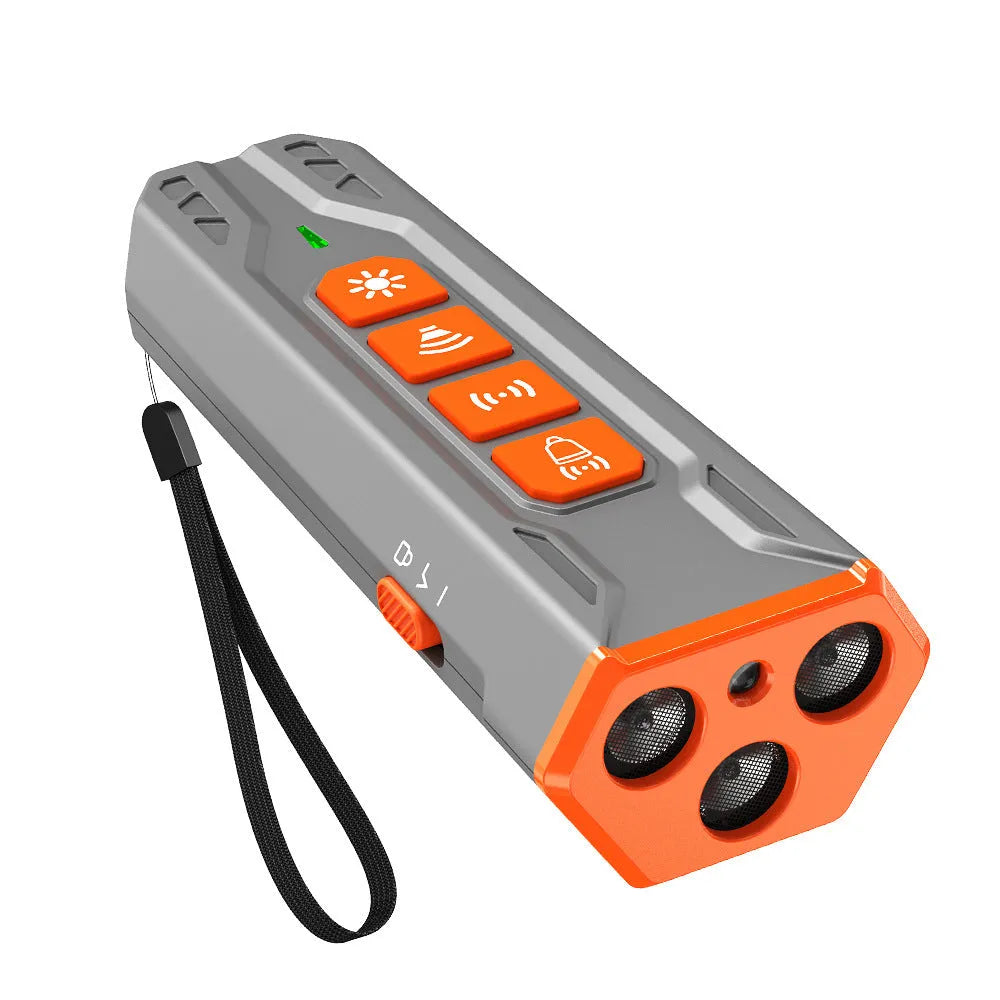 Handheld grey and orange ultrasonic dog trainer with three heads and a remote control.