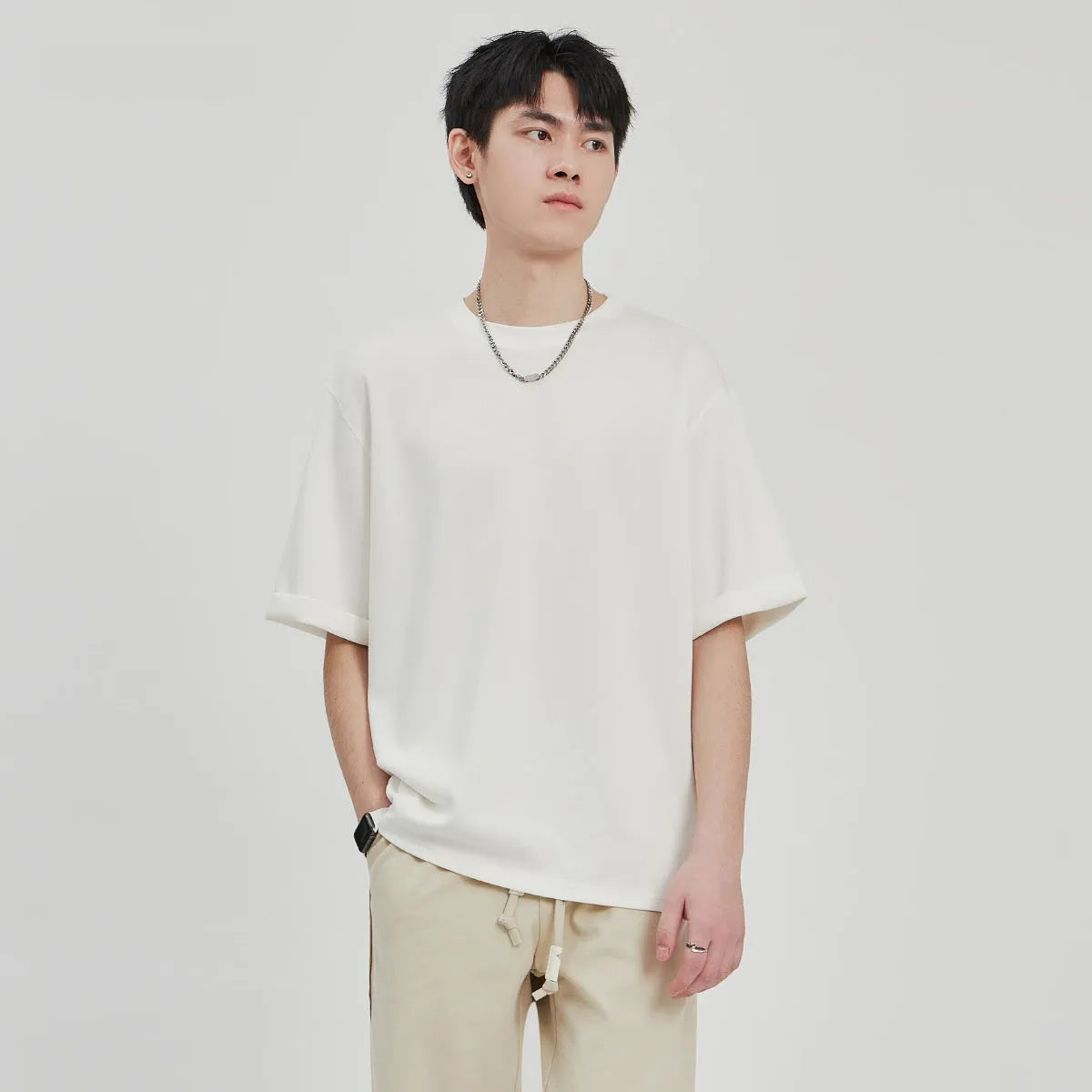 Men's brown drape knit loose t-shirt with short sleeves on a hanger.