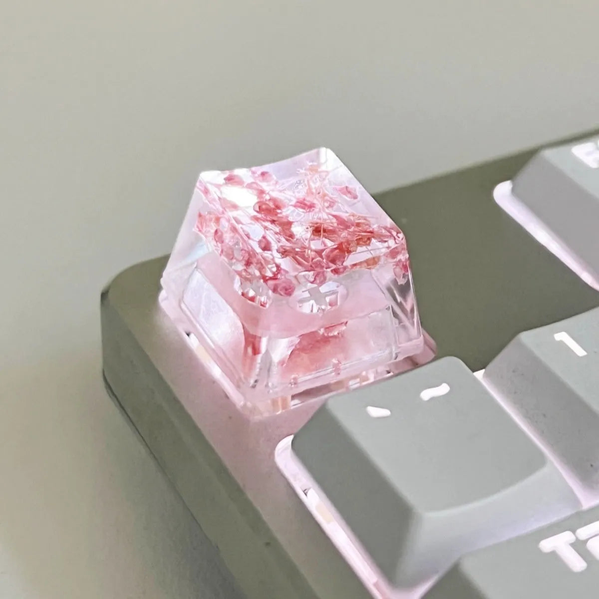 Transparent resin mechanical keyboard keycap with glitter starry sky effect in red, pink, green, or violet.