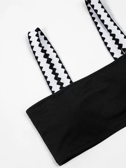 Black women's hollowed-out split swimsuit bikini set on a model.