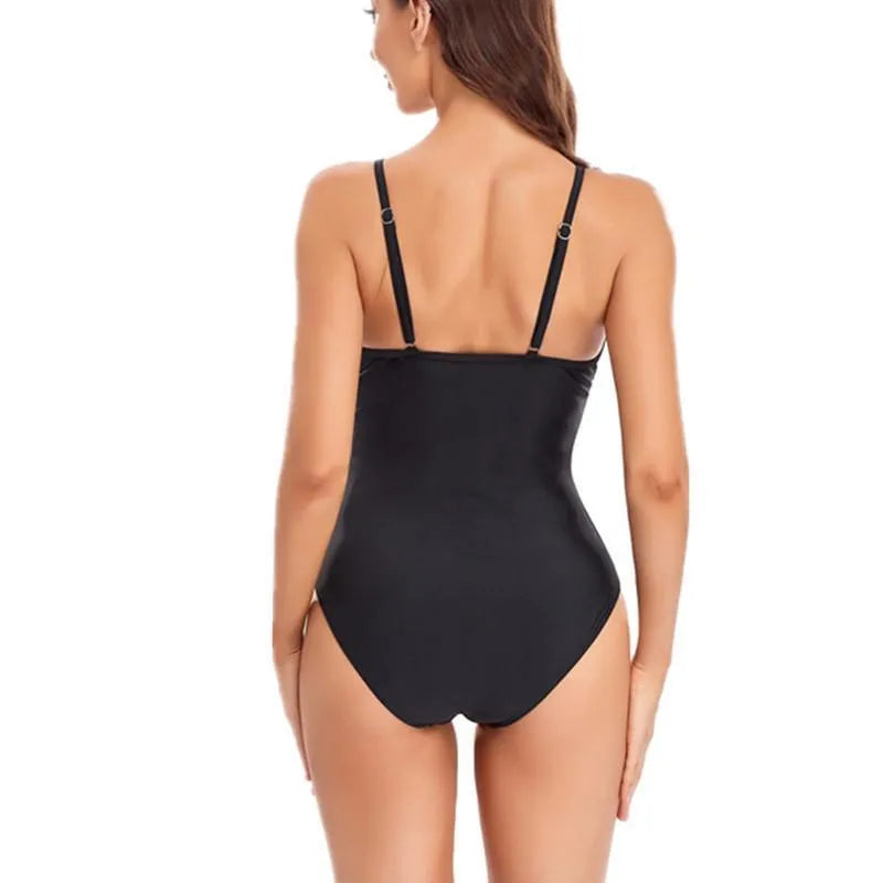 Ladies black mesh backless one-piece swimsuit made from spandex on a mannequin.