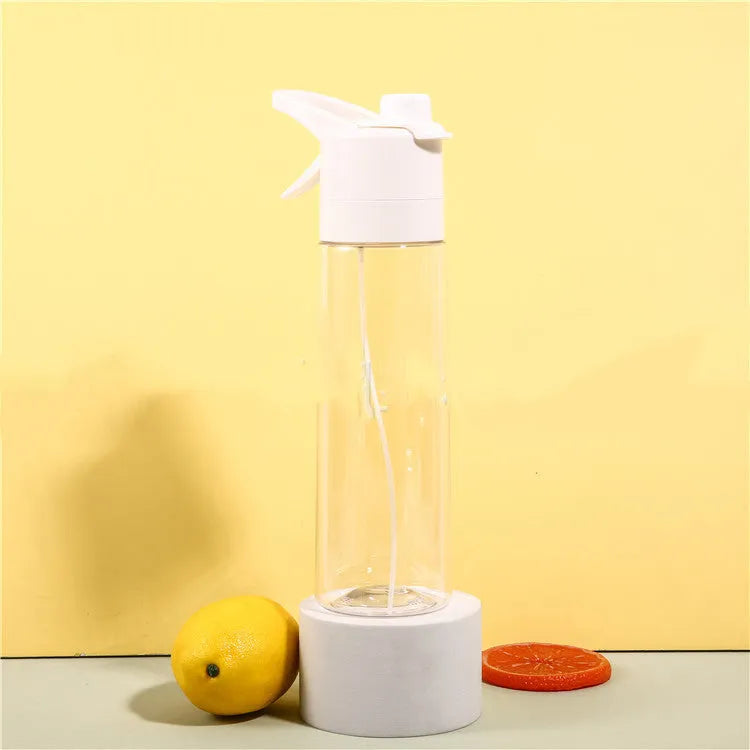 White spray water bottle with black leakproof lid and handle strap on a table