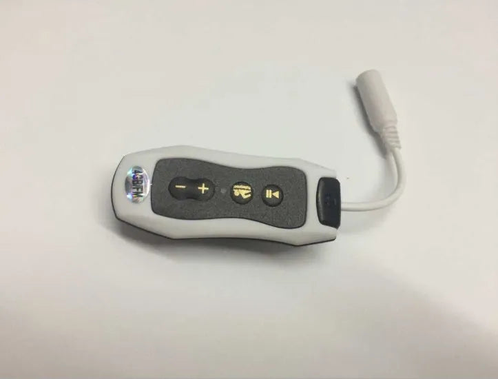 Compact black Bluetooth MP3 headset with clip, shown next to USB charging cable.