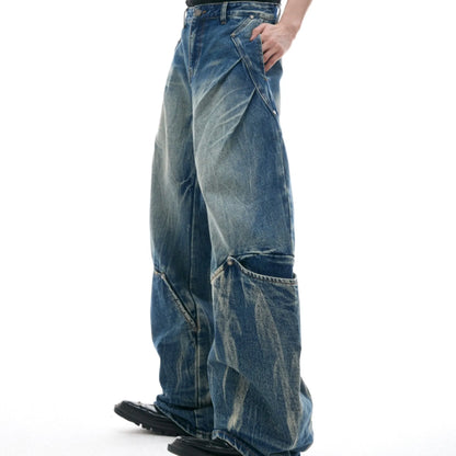 Men's verdant blue jeans with burst pattern, curved knife cut, and loose fit design