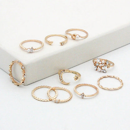 Gold-plated adjustable ring set with moon, star, and leaf charms in a bohemian style