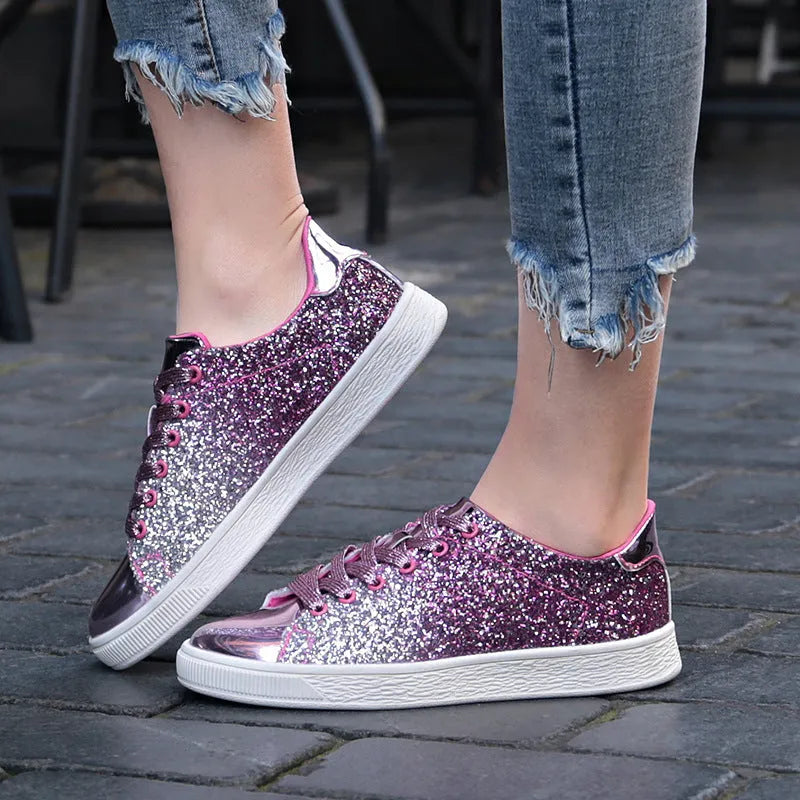 Women's low-top casual shoes with black sequin upper, round toe, and white rubber sole with lace-up closure.