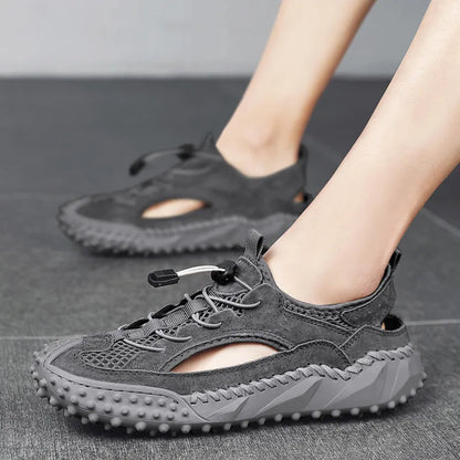 Men's black waterproof wading sandals with elastic band and perforated leather mesh upper on a rubber sole.