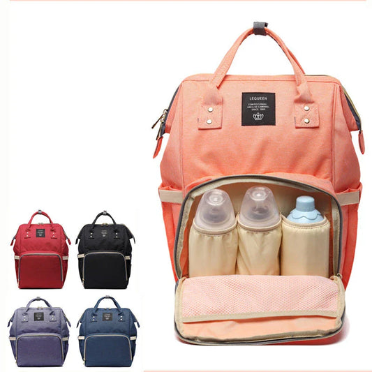 Stylish maternity diaper bag in various colors, featuring a paper bag design, separate bottle compartment, and discreet breastfeeding button.