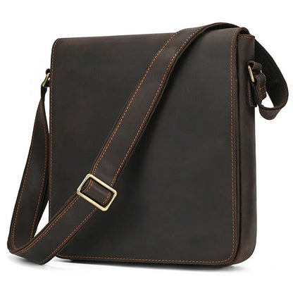 Men's brown first layer cowhide leather shoulder bag with crossbody strap and visible sewing line details.