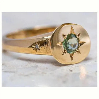 Golden ring with oval asterism zircon, star shape, and adjustable opening on a plain background