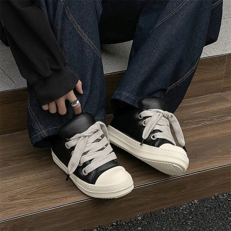 Black men's slip-on casual shoes with leather upper, rubber sole, and raised platform design
