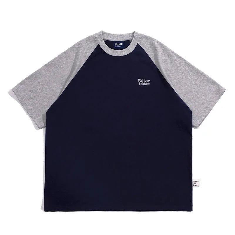 Men's blue loose-fit Japanese style long sleeve t-shirt with raglan sleeves on a hanger.