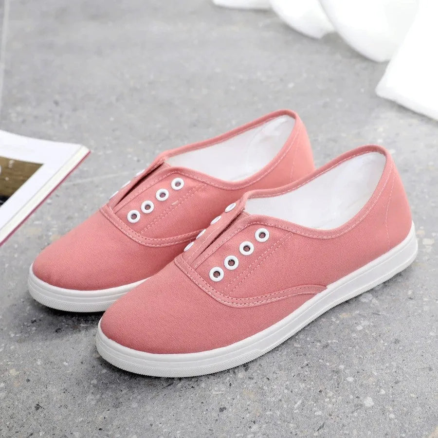 A pair of low-top canvas casual trainers in a choice of colours, shown on a flat surface.