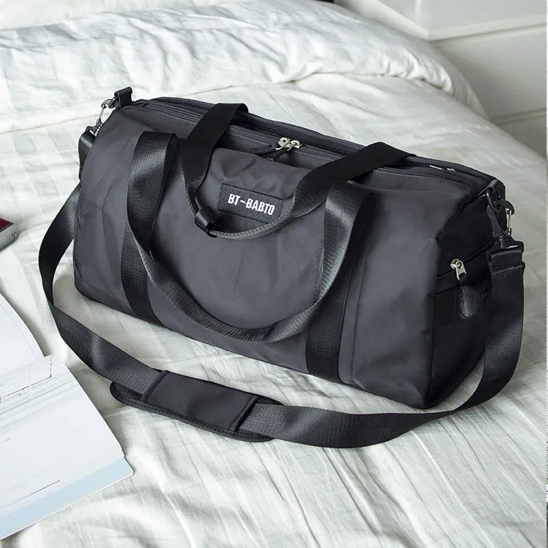 Beige casual sports bag with letter pattern and contrast colour details.