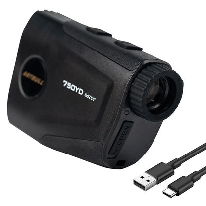 Black golf laser rangefinder with LCD display showing yardage, placed on a green golf towel.