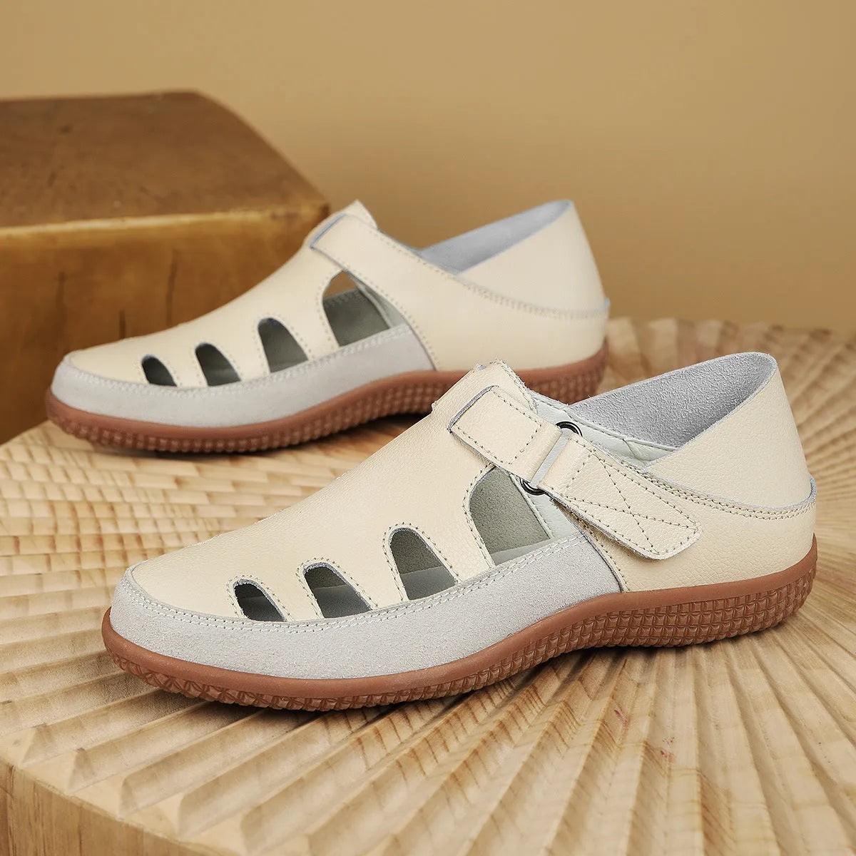Plus size women's flat sandals with toe cap, hollow design, and thick rubber sole in blue.