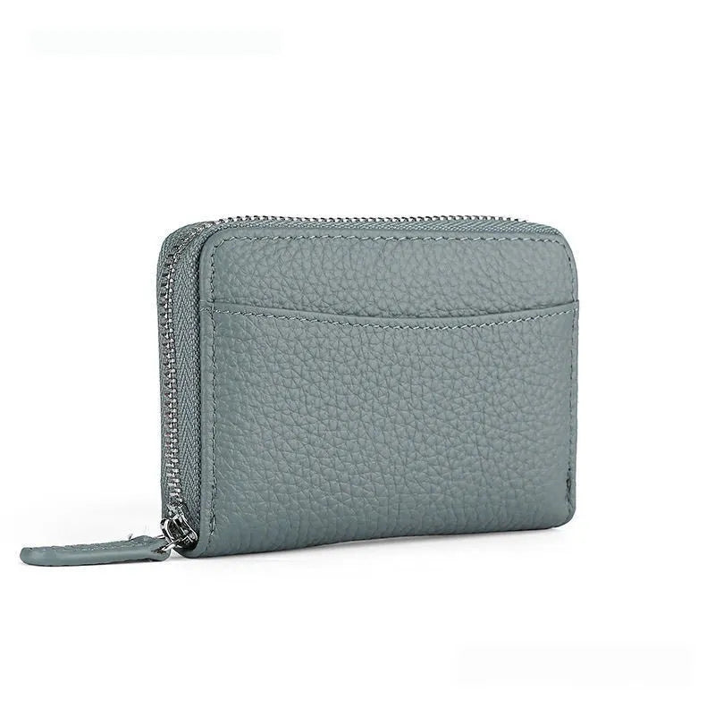 Genuine leather zipper coin purse in a solid colour showing sewing line detail.