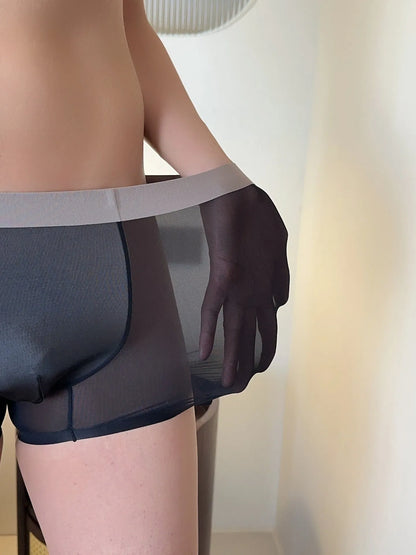 Ultra-thin seamless men's boxers in black with a honeycomb crotch design, laid flat.