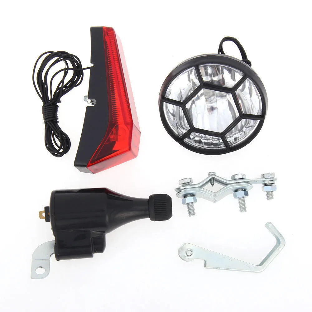 Silver dynamo-powered bicycle light set with generator unit for friction drive on wheel.