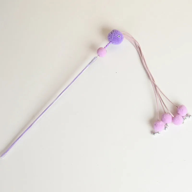 Set of four colourful cat stick toys with dangling tassels, showing blue, pink, and purple handles.
