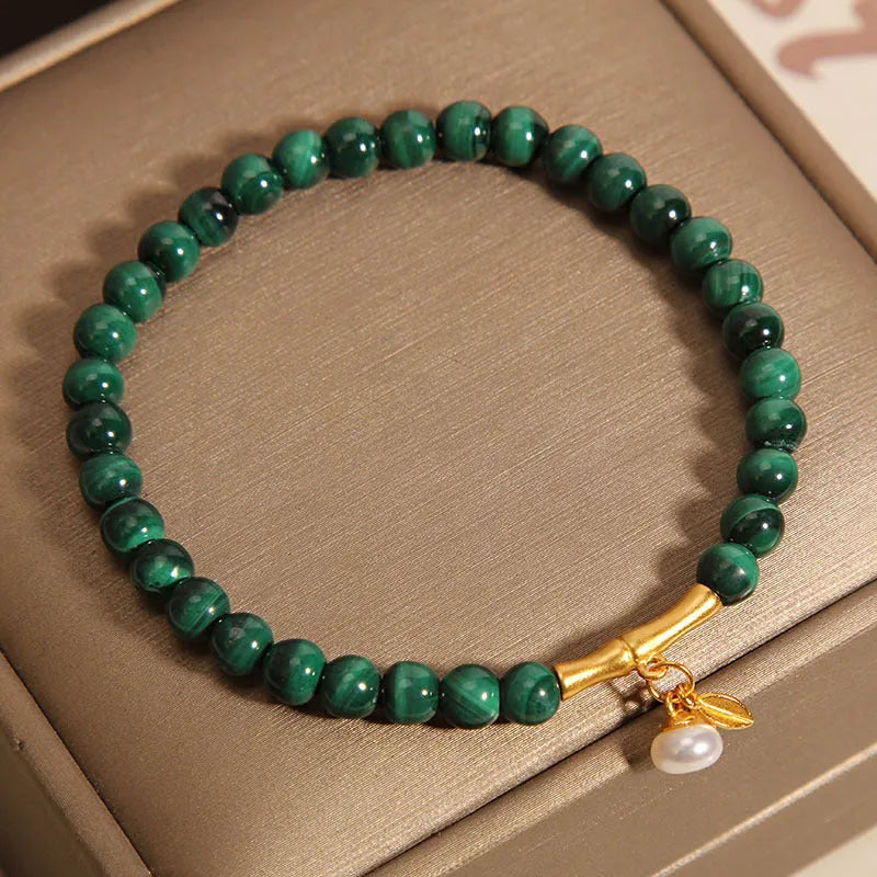 Close-up of a women's adjustable white crystal bracelet featuring a high-rise lucky bamboo design on a wrist.