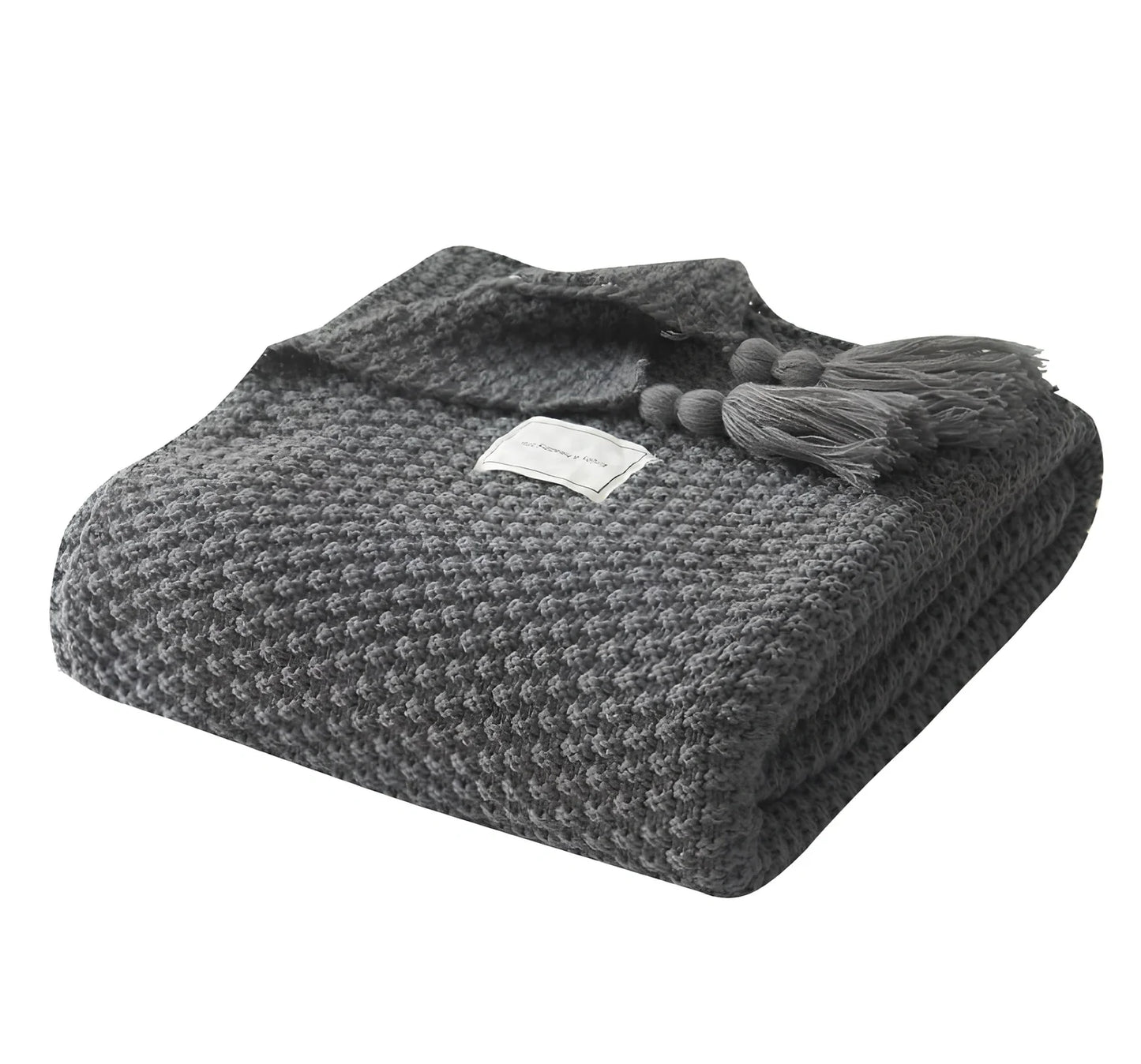 Fringed knitting blanket in beige colour showing 5cm fringe detailing and dense acrylic weave texture